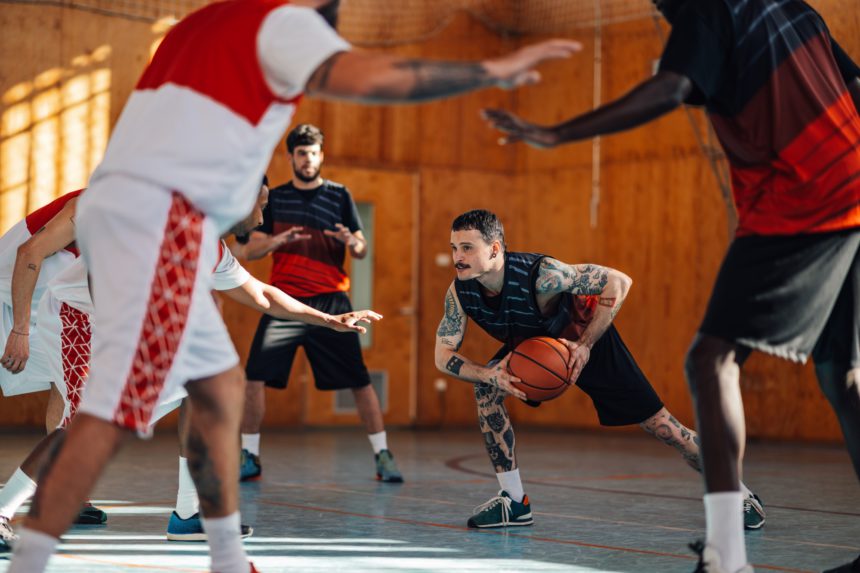 Diverse basketball players in action playing a basketball on training.
